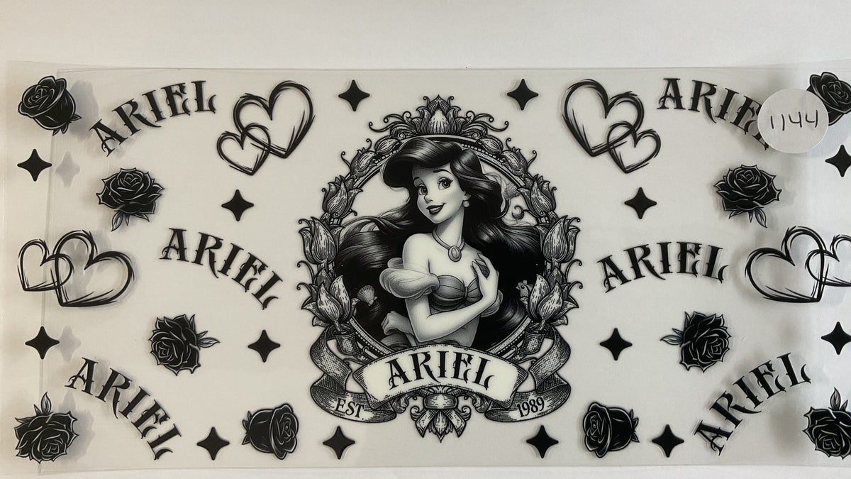 A sheet of black and white temporary tattoos featuring the name 'Ariel' in multiple styles, double hearts, roses, and a central framed illustration of Ariel from The Little Mermaid.