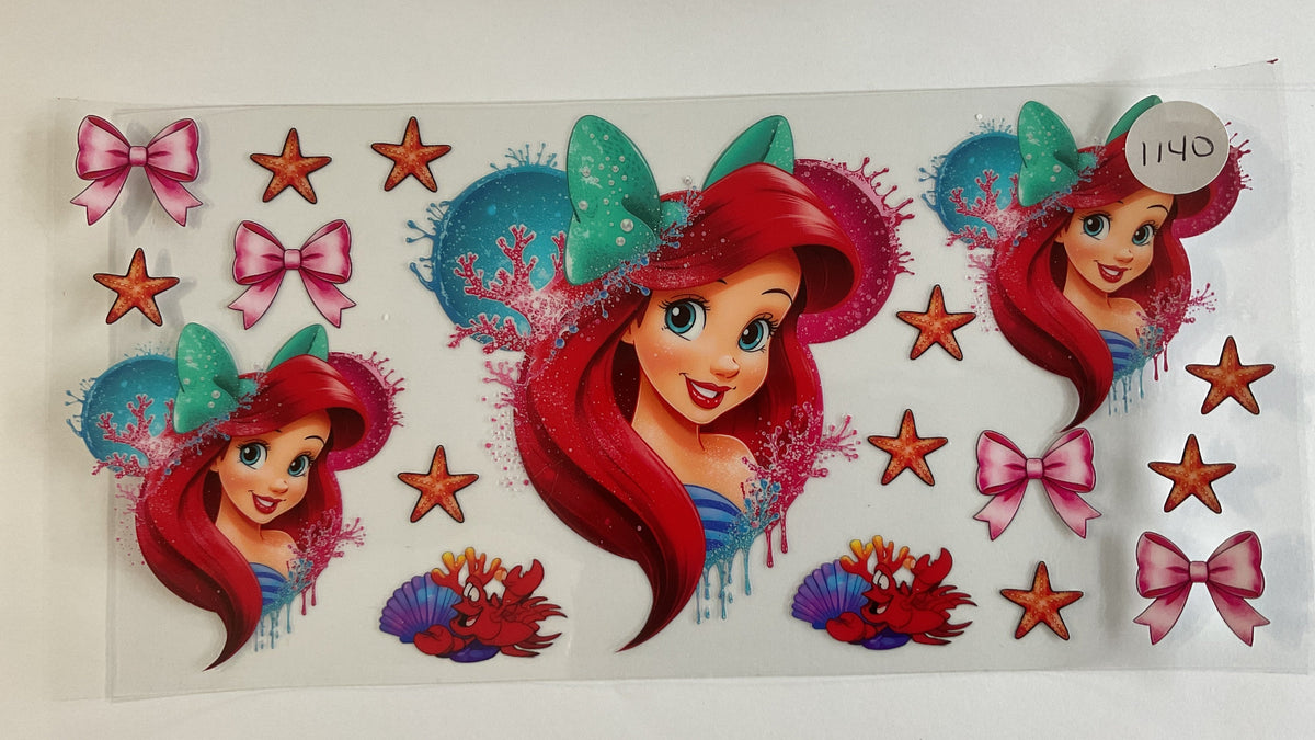 A sheet of decorative stickers featuring Disney's The Little Mermaid, including Ariel, pink bows, orange starfish, and sea-themed motifs on a white backing.